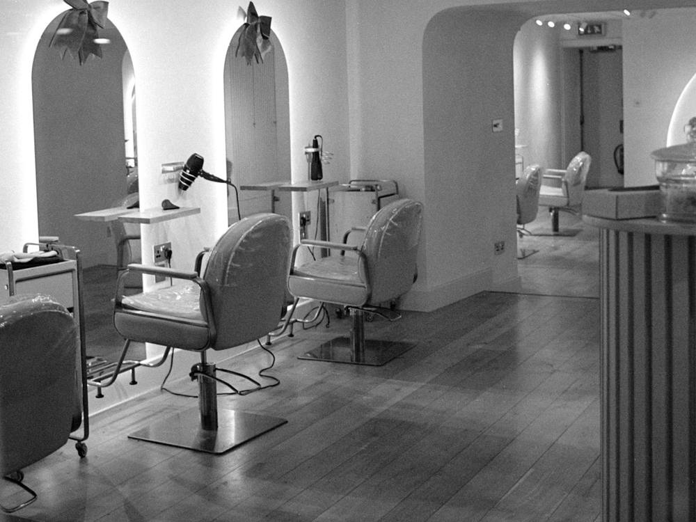 Salon interior with styling chairs and arched mirrors