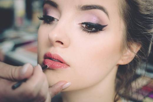 Lipstick being applied by a makeup artist